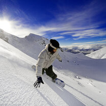 Snowboarding in the Southern Alps near Queenstown, South Island Canadians can ski or snowboard the Southern Alps while on working holiday in New Zealand